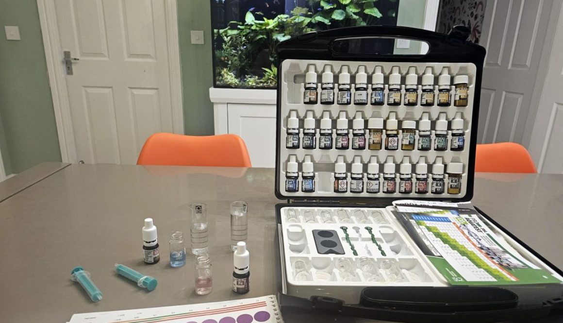Aquarium testing kit with various bottles and testing equipment
