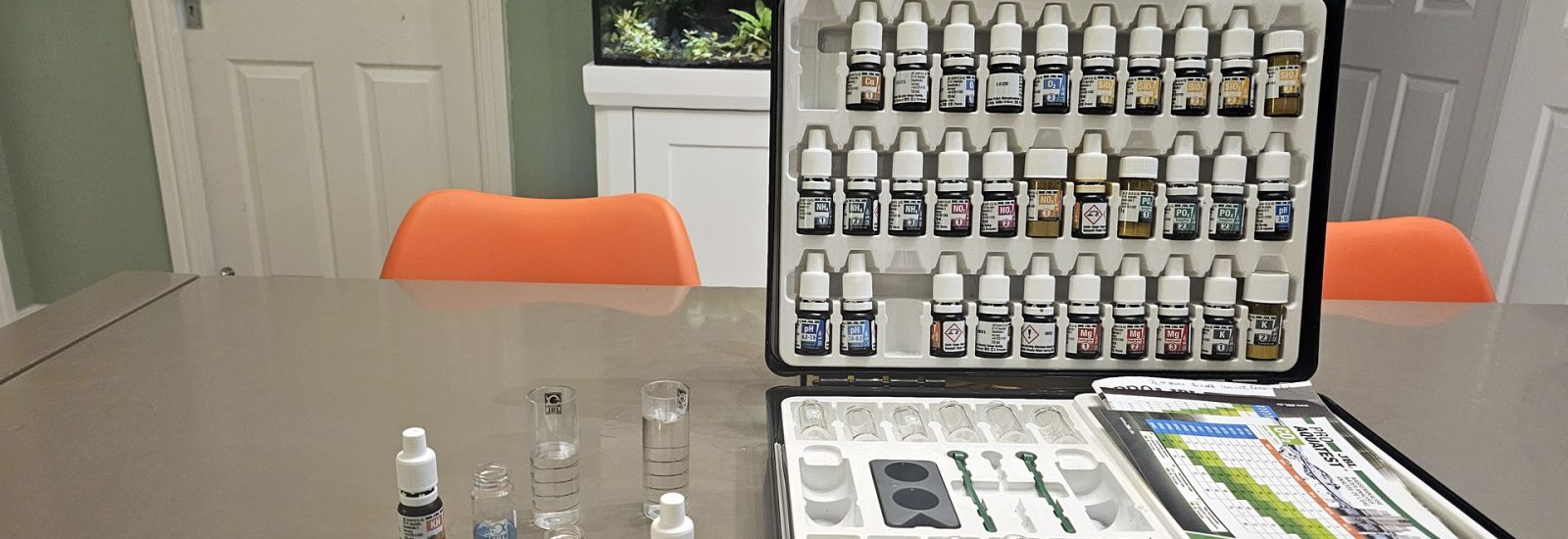 Aquarium testing kit with various bottles and testing equipment